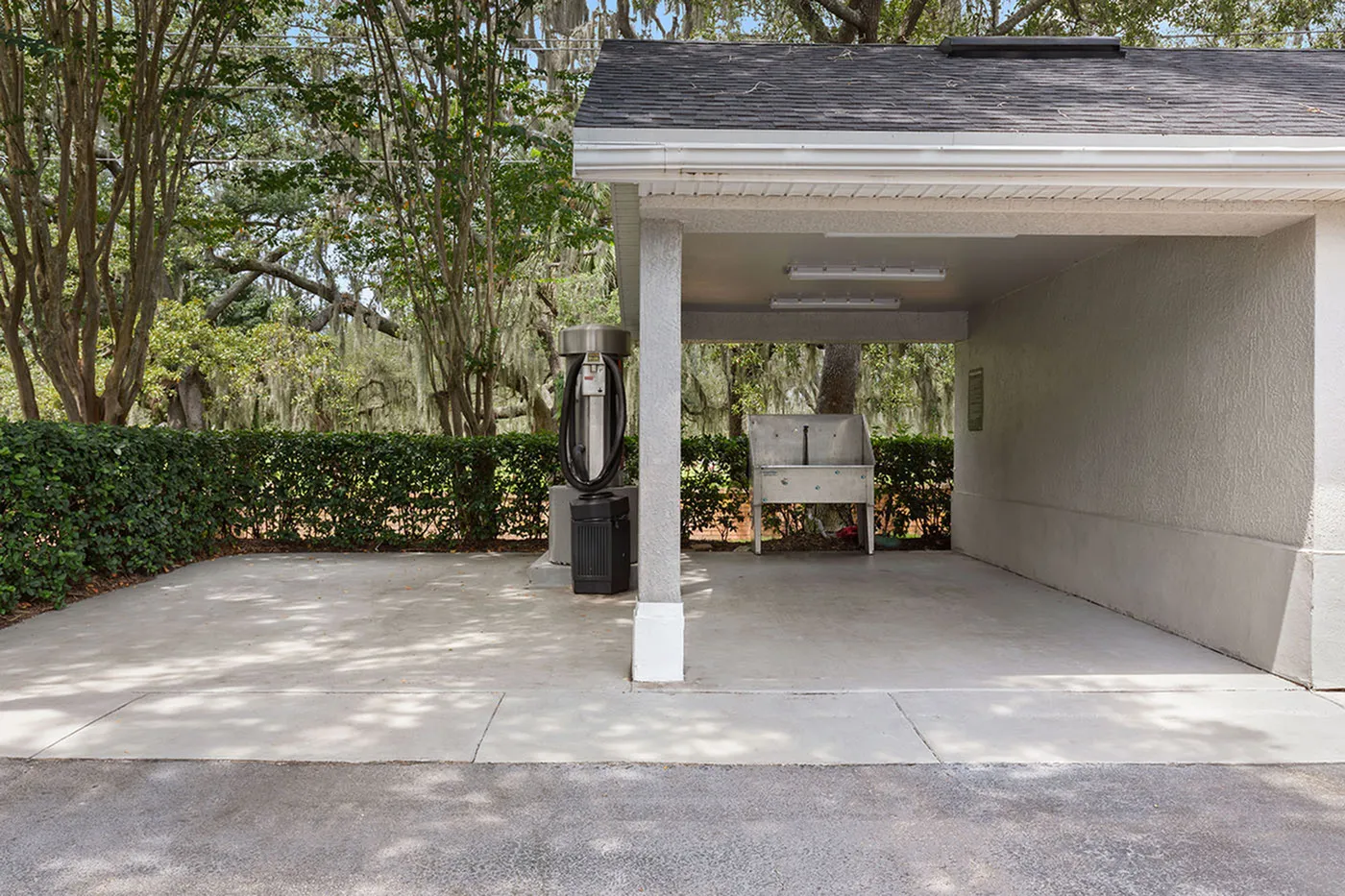 Elegant outdoor carport featuring lush greenery and modern design, perfect for convenience and style.