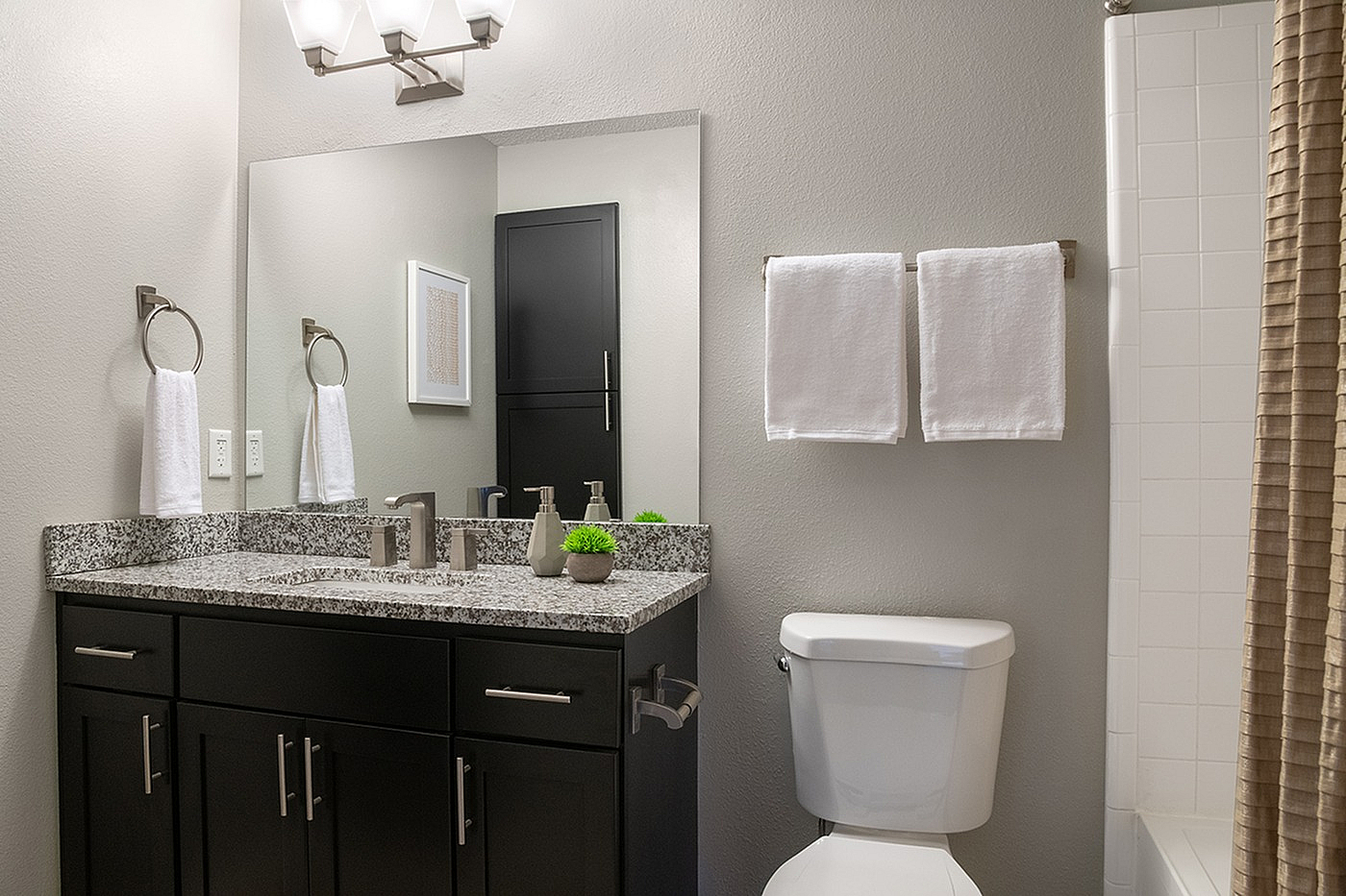 Elegant modern bathroom with sleek granite countertop, stylish fixtures, and soft lighting creating a serene atmosphere.