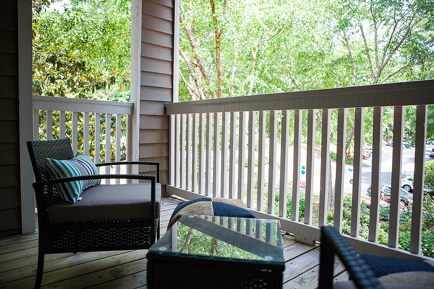 Charming outdoor patio with cozy seating, perfect for relaxing and enjoying lush green views.