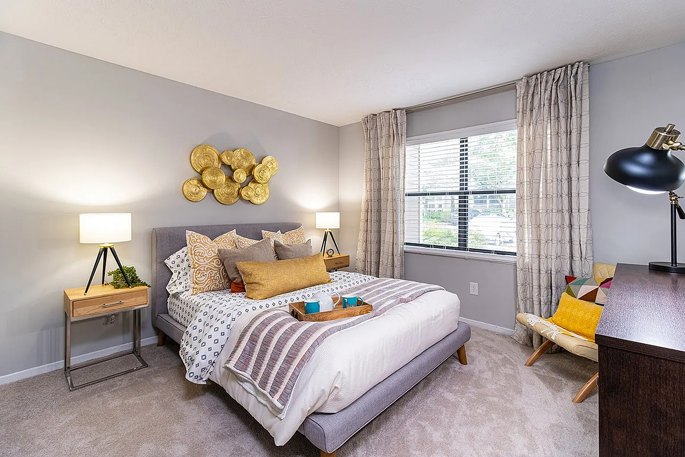 Chic and cozy bedroom with modern decor, plush bedding, and warm lighting, perfect for relaxation and comfort.