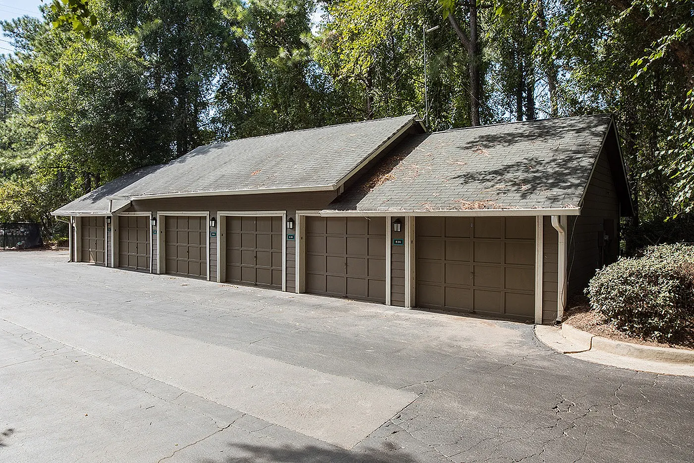 Charming multi-car garage nestled in a serene wooded setting, perfect for secure and convenient parking.