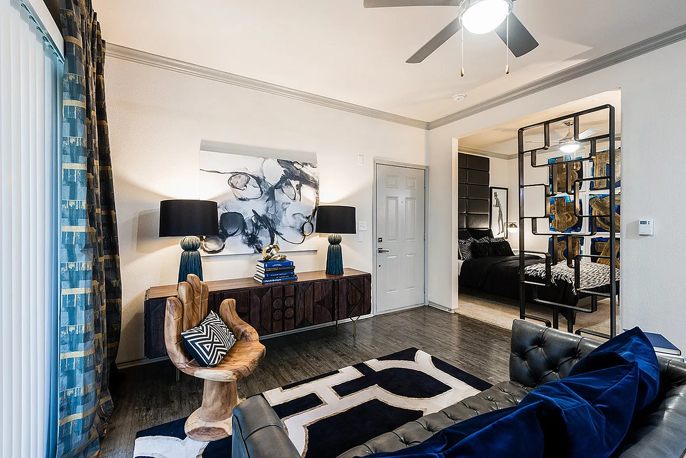 Contemporary living space with chic decor, stylish room divider, and cozy bedroom view.