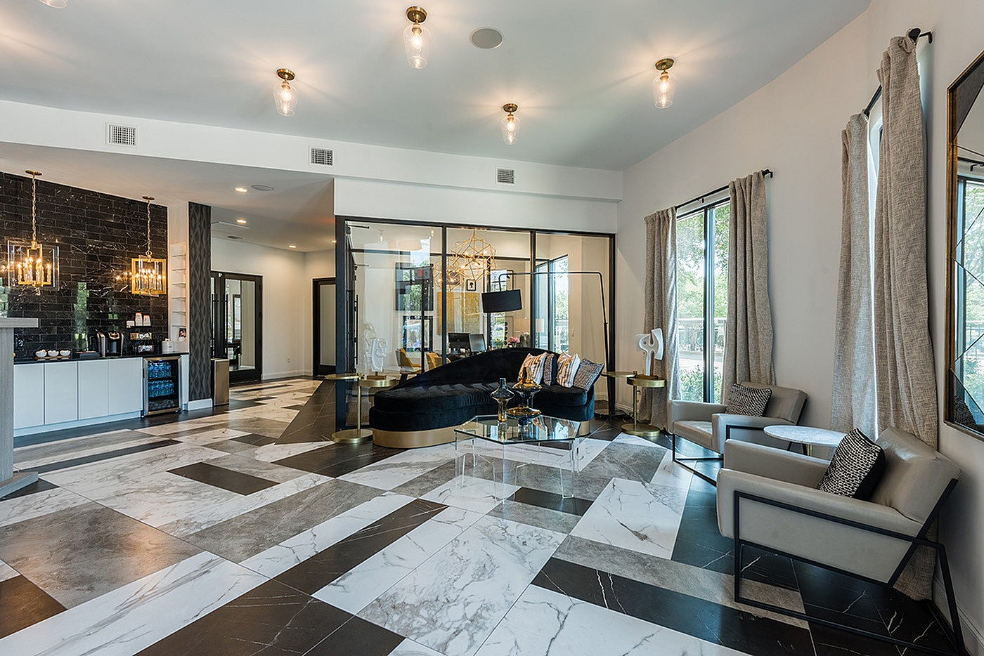 Elegant apartment lobby with marble floors, stylish seating, and contemporary lighting creating a luxurious ambiance.