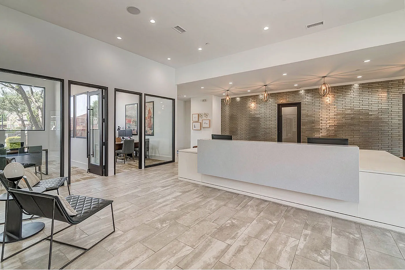 Elegant office reception area with modern design, featuring stylish seating, contemporary lighting, and private meeting rooms.