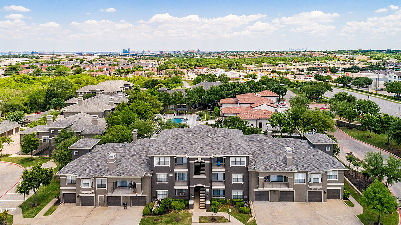 Charming apartment complex with elegant architecture, nestled in lush greenery, offering serene views and modern amenities.