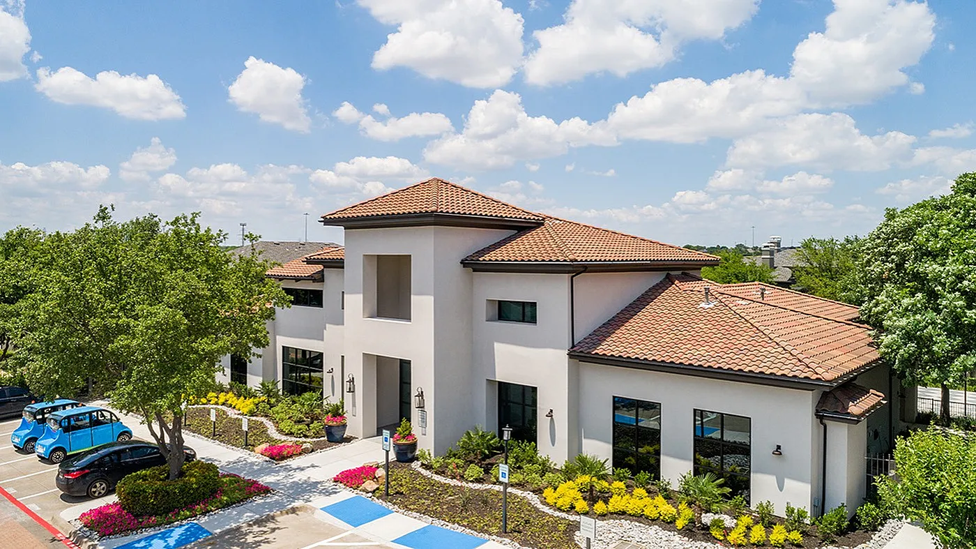 Modern apartment community with Mediterranean-style architecture, lush landscaping, and charming outdoor spaces.