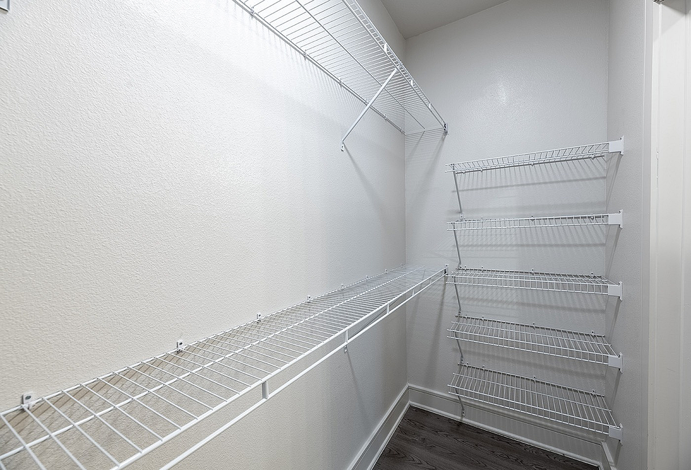 Spacious walk-in closet with organized wire shelving and ample storage space.