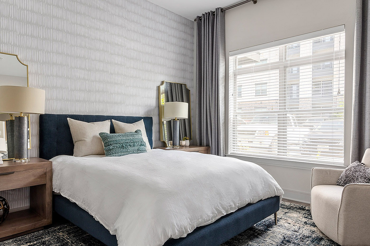 Bright and elegant bedroom with a plush bed, stylish decor, and large window for abundant natural light.