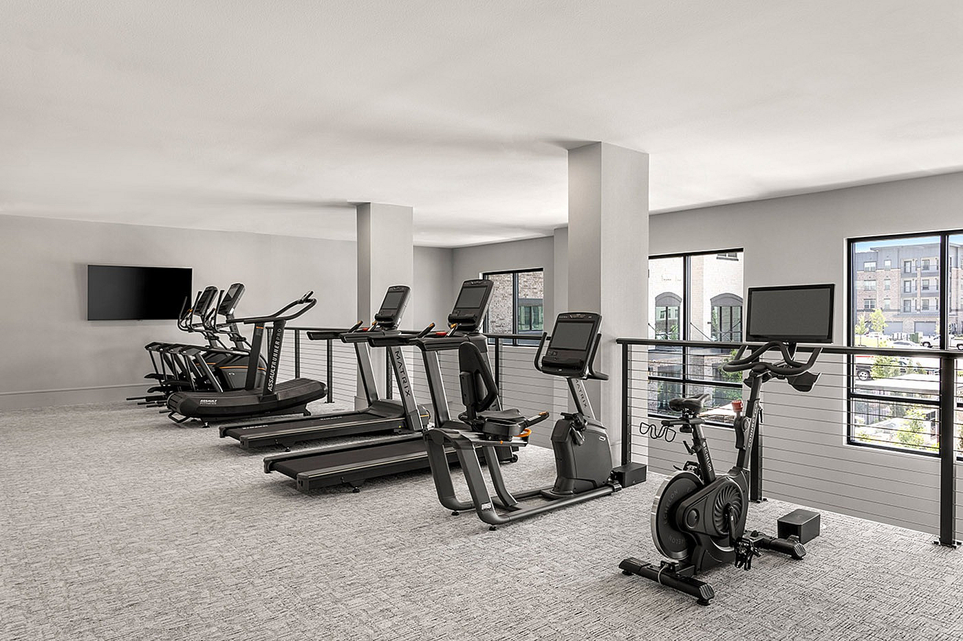 Modern fitness center with state-of-the-art treadmills and exercise bikes, offering a bright and spacious workout environment.