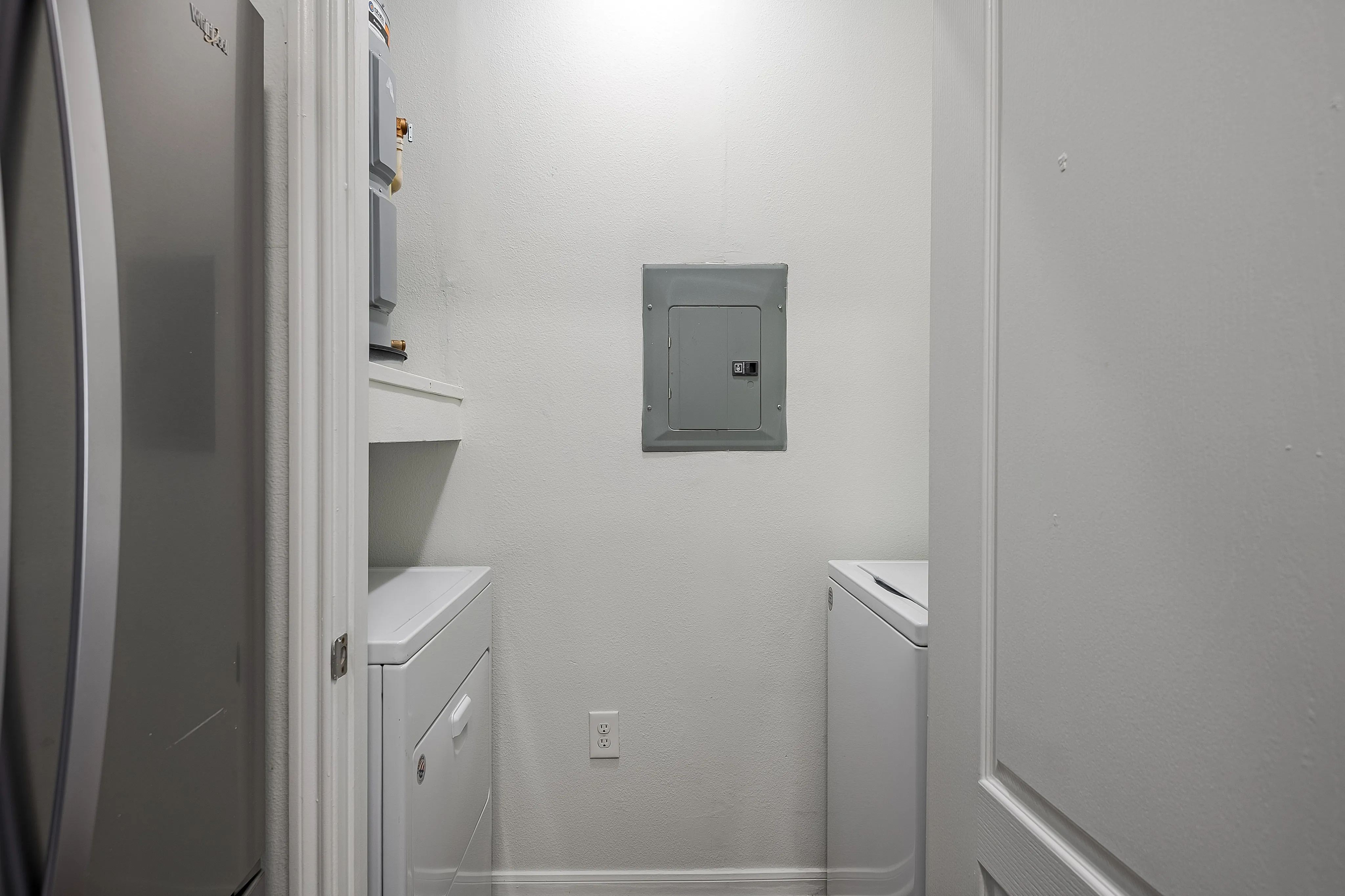 Compact and efficient laundry room with modern appliances and sleek design.