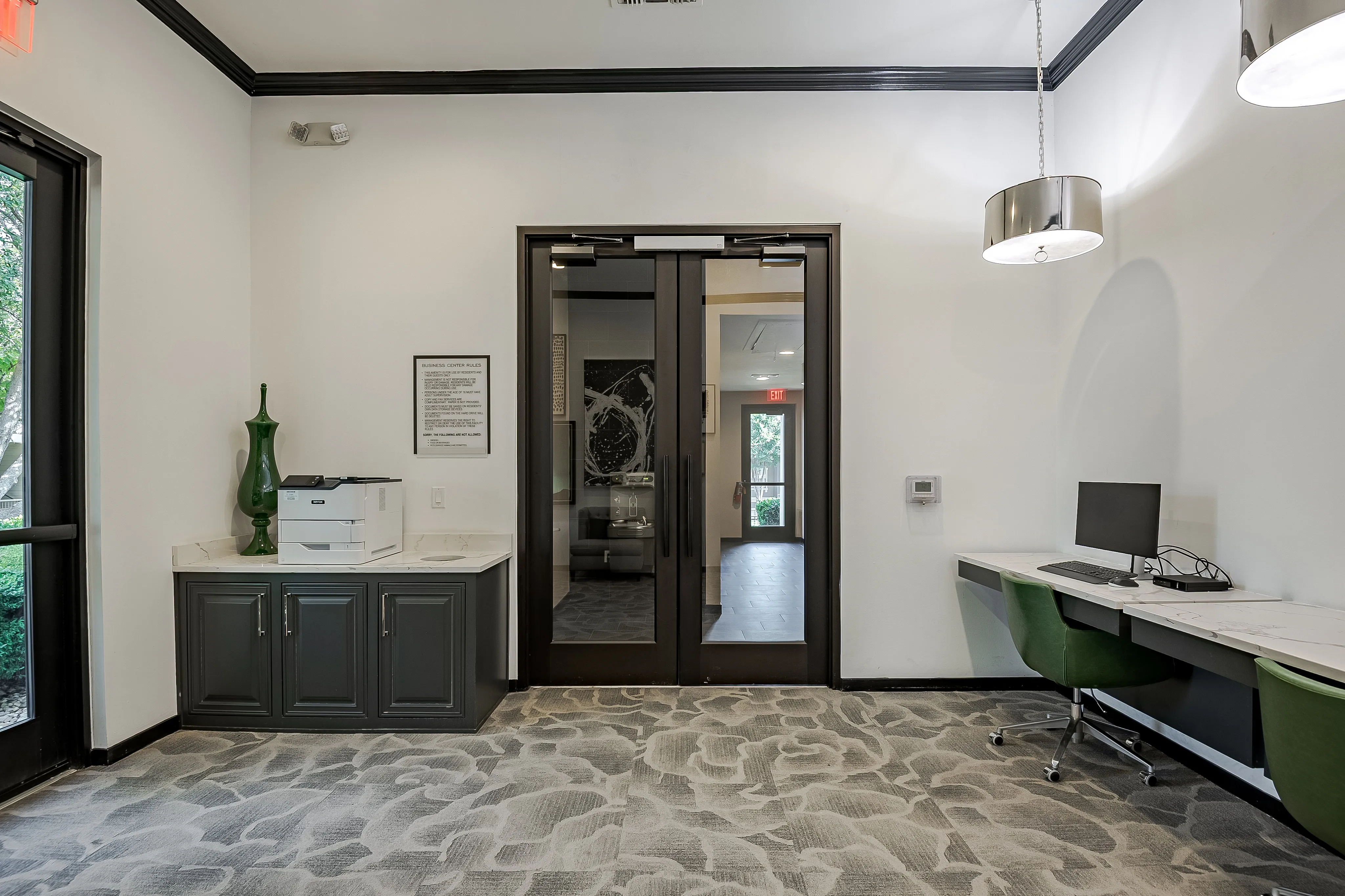 Elegant office area with sleek computer workstation, modern office chairs, and spacious printer counter.