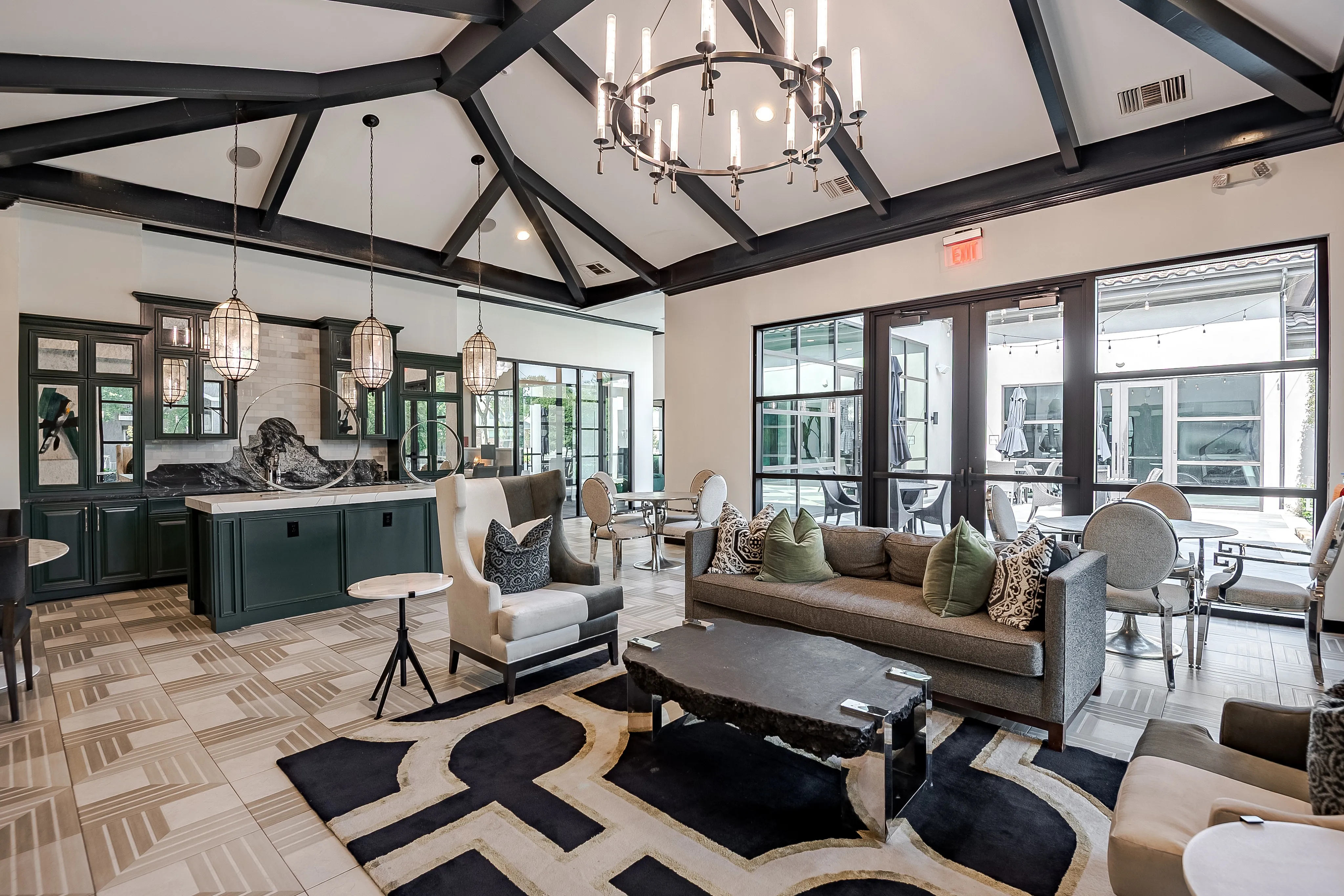 Luxurious open-concept lounge featuring elegant sofas, modern lighting, and spacious windows with a blend of classic and contemporary design elements.