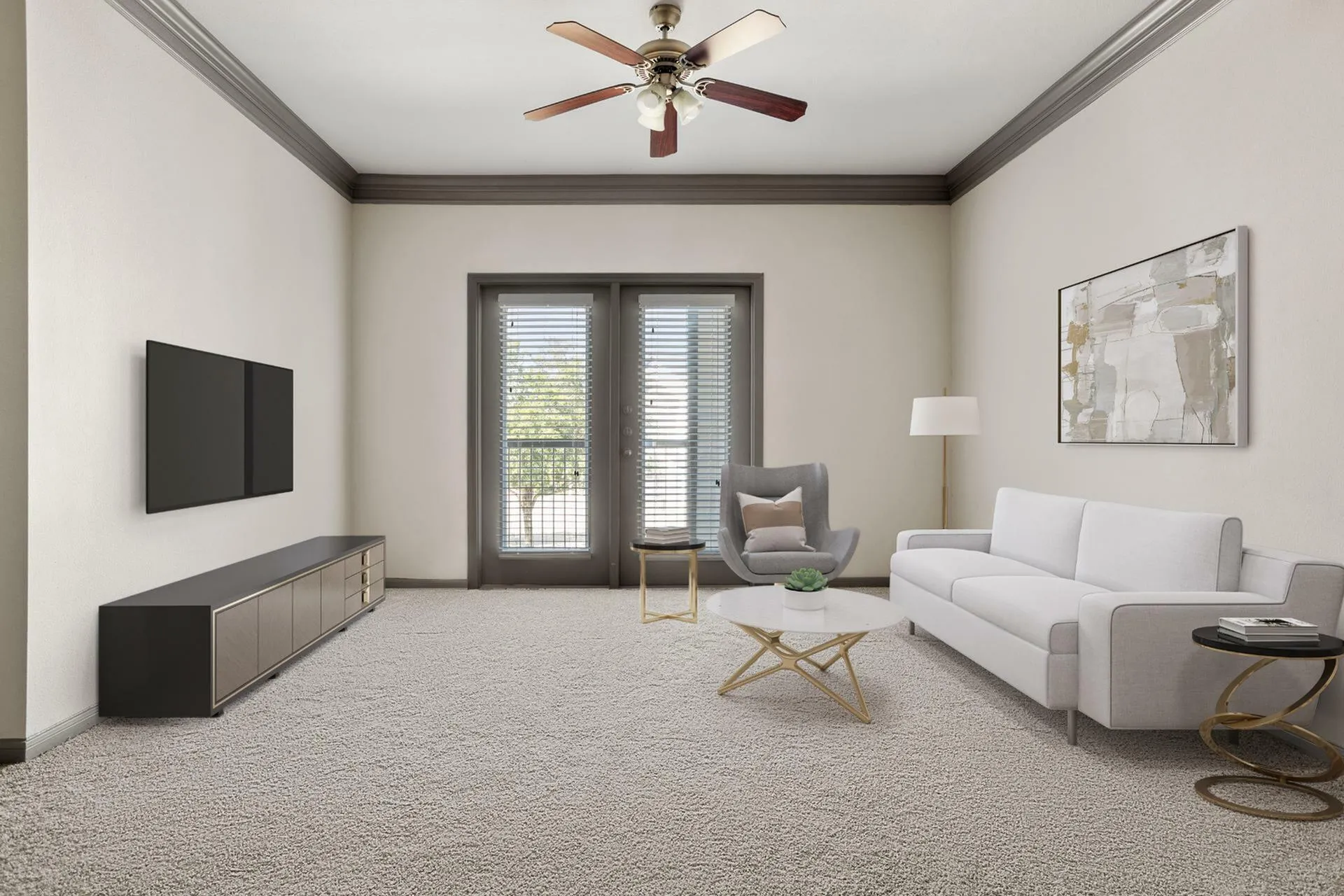 Bright and inviting living room with elegant furniture, featuring a plush gray couch, modern armchair, and stylish coffee table. Natural light streams in through wide double doors, highlighting the soft carpeting and sleek ceiling fan.