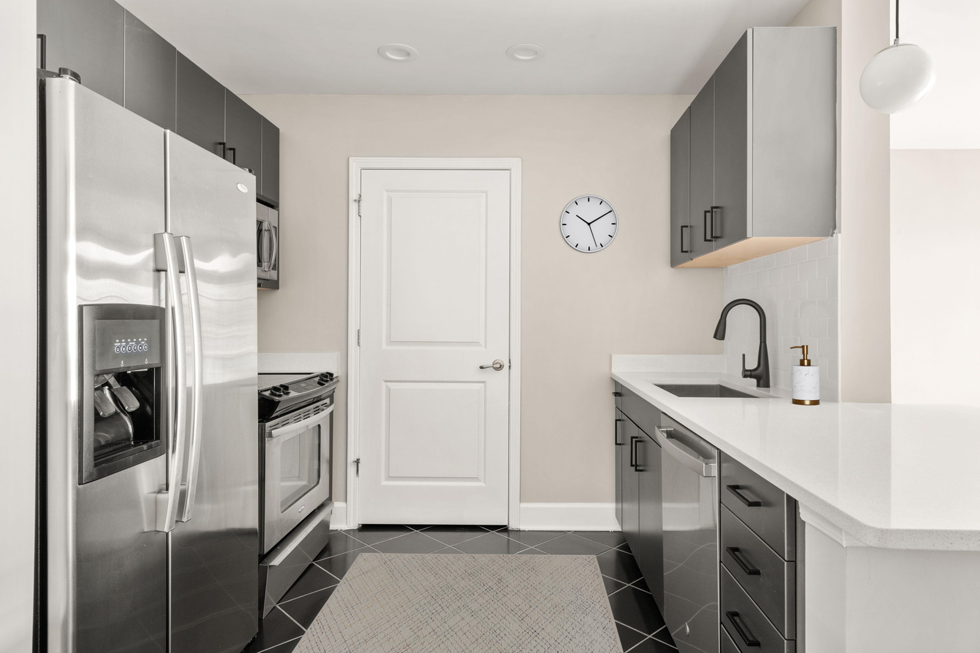Sleek modern kitchen with stainless steel appliances, elegant cabinetry, and minimalist design.