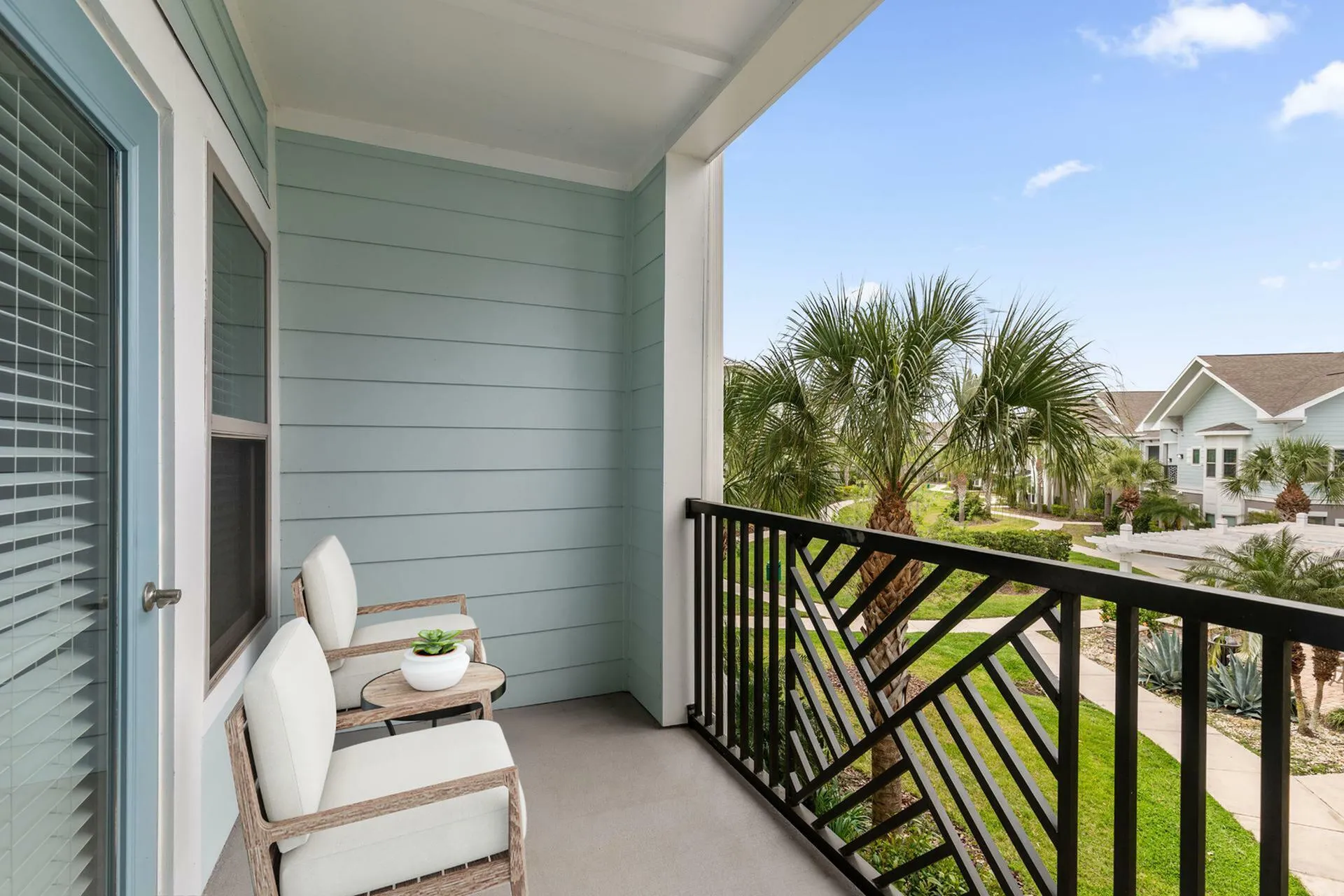 Inviting balcony with modern seating and lush greenery views, ideal for relaxation.