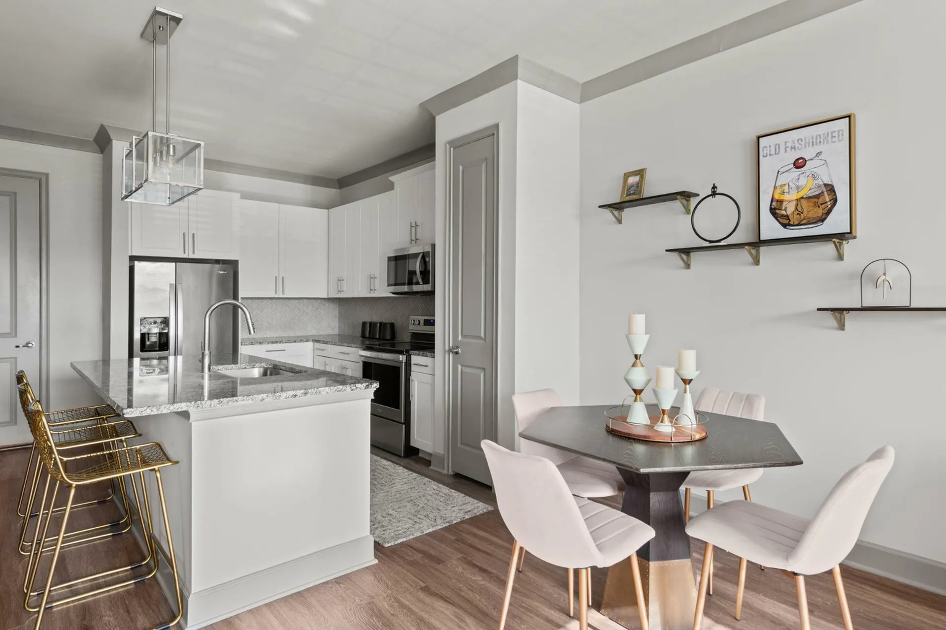 Chic modern kitchen with elegant marble countertops, stylish breakfast bar seating, and cozy dining nook in a spacious open-plan apartment.