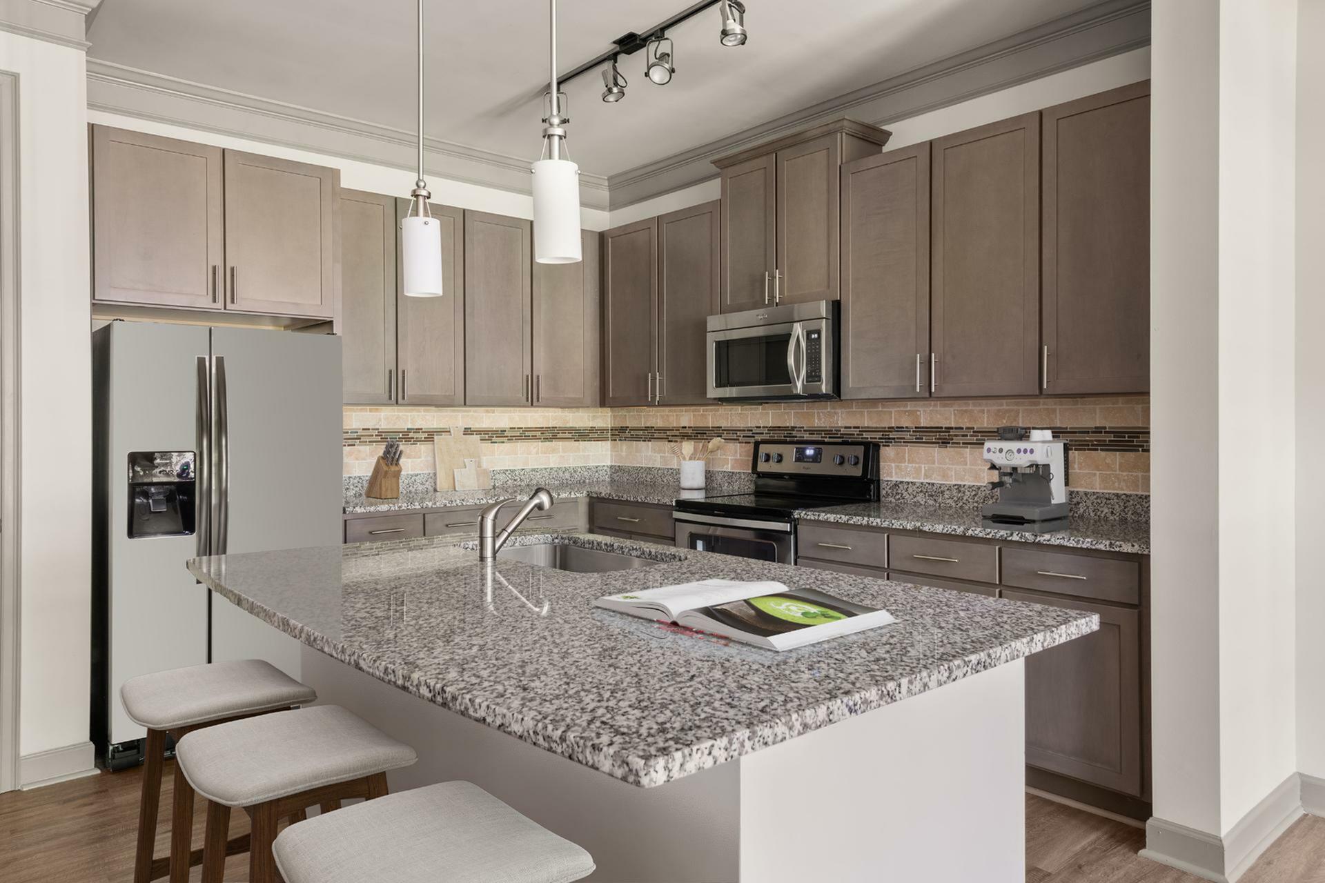 Sophisticated modern kitchen with granite countertops, sleek cabinetry, and stainless steel appliances.