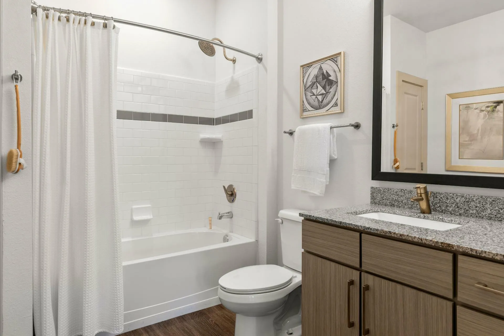 Modern bathroom with elegant tiles, granite countertop, and stylish fixtures for a comfortable living experience.