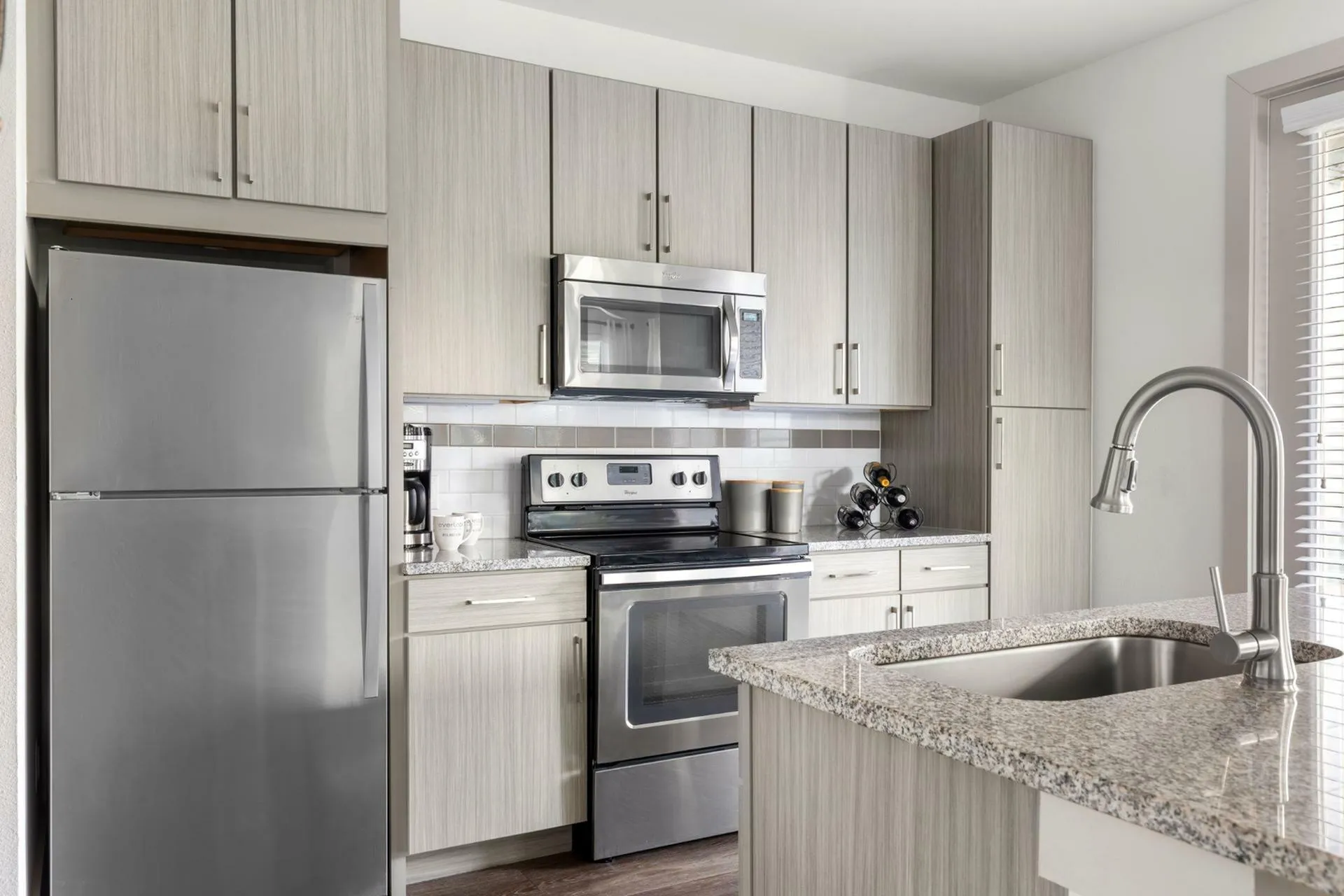 Modern kitchen design with sleek stainless steel appliances, elegant granite countertops, and stylish cabinetry providing ample storage space.