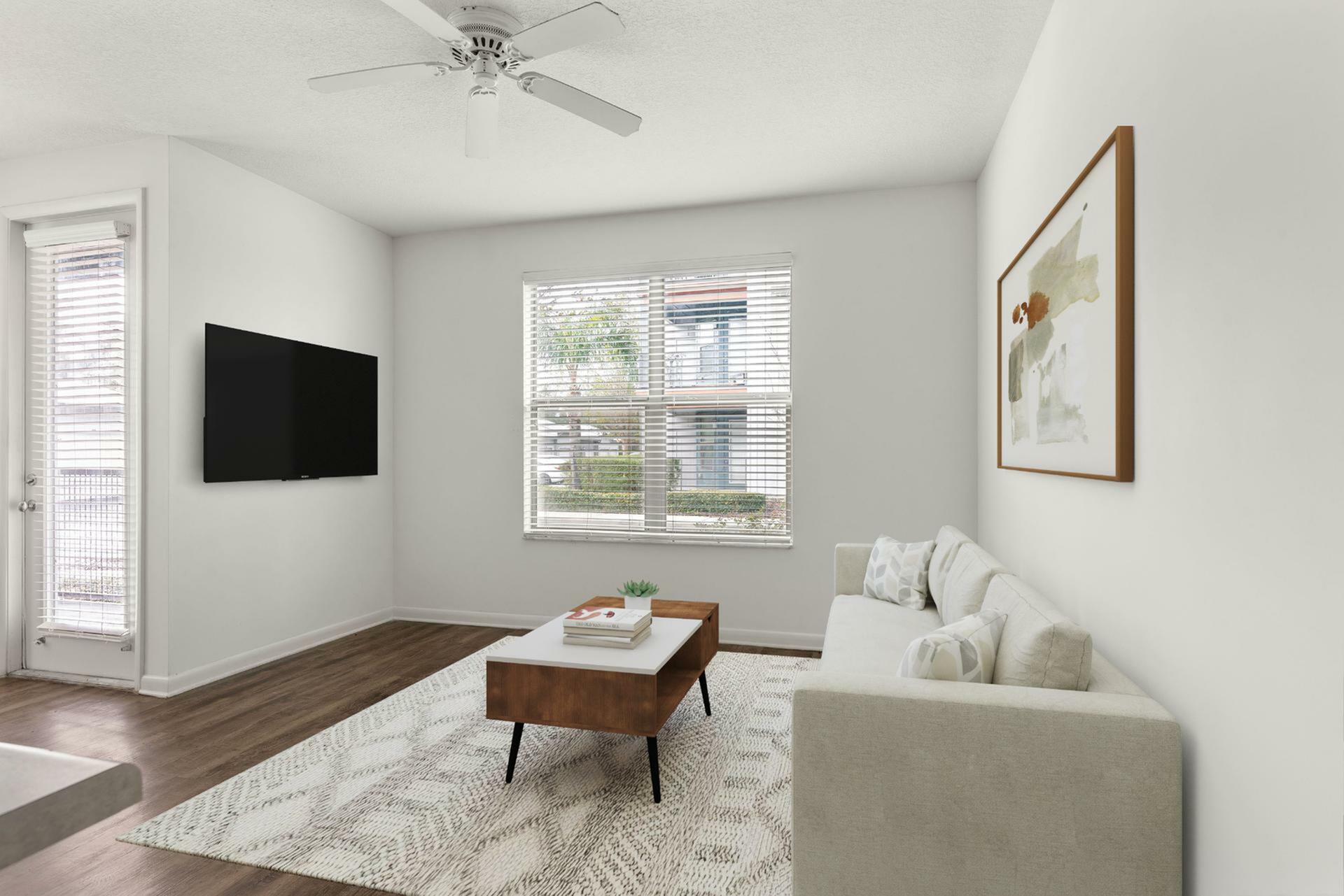 Bright and inviting living room with a modern sofa, elegant decor, and natural light streaming through large windows.