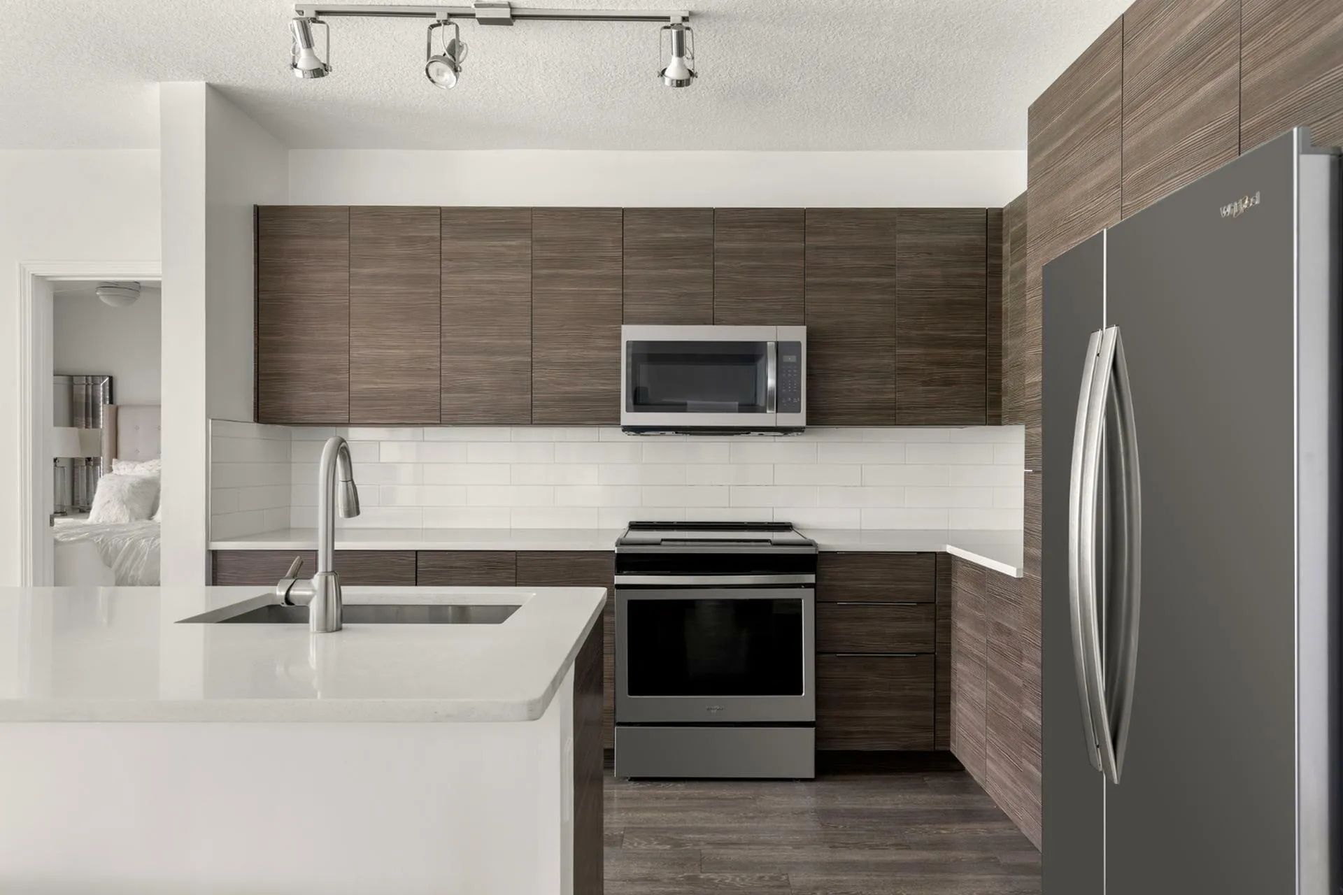 Modern kitchen with sleek cabinetry, stainless steel appliances, and elegant countertops.