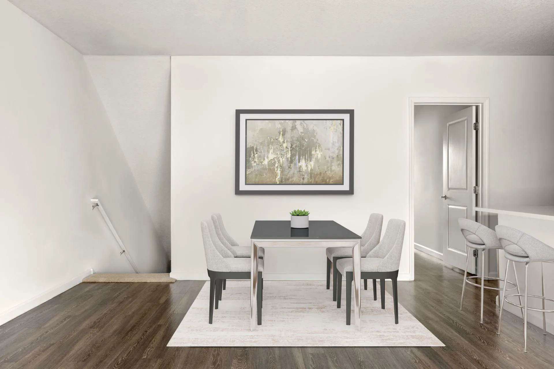 Elegant dining area with sleek table set for six, modern artwork, and cozy bar stools in a stylish apartment.