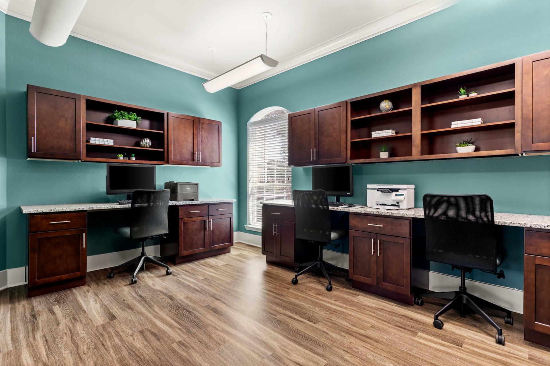 Chic home office with dual workstations, elegant wooden cabinetry, and vibrant teal walls, perfect for productivity and style.