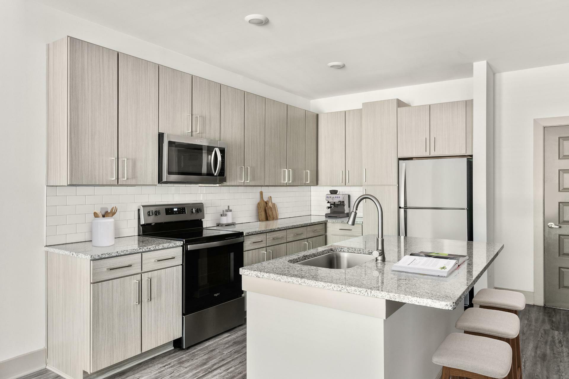Modern kitchen with sleek cabinetry, granite countertops, and stainless steel appliances, exuding sophistication and style.