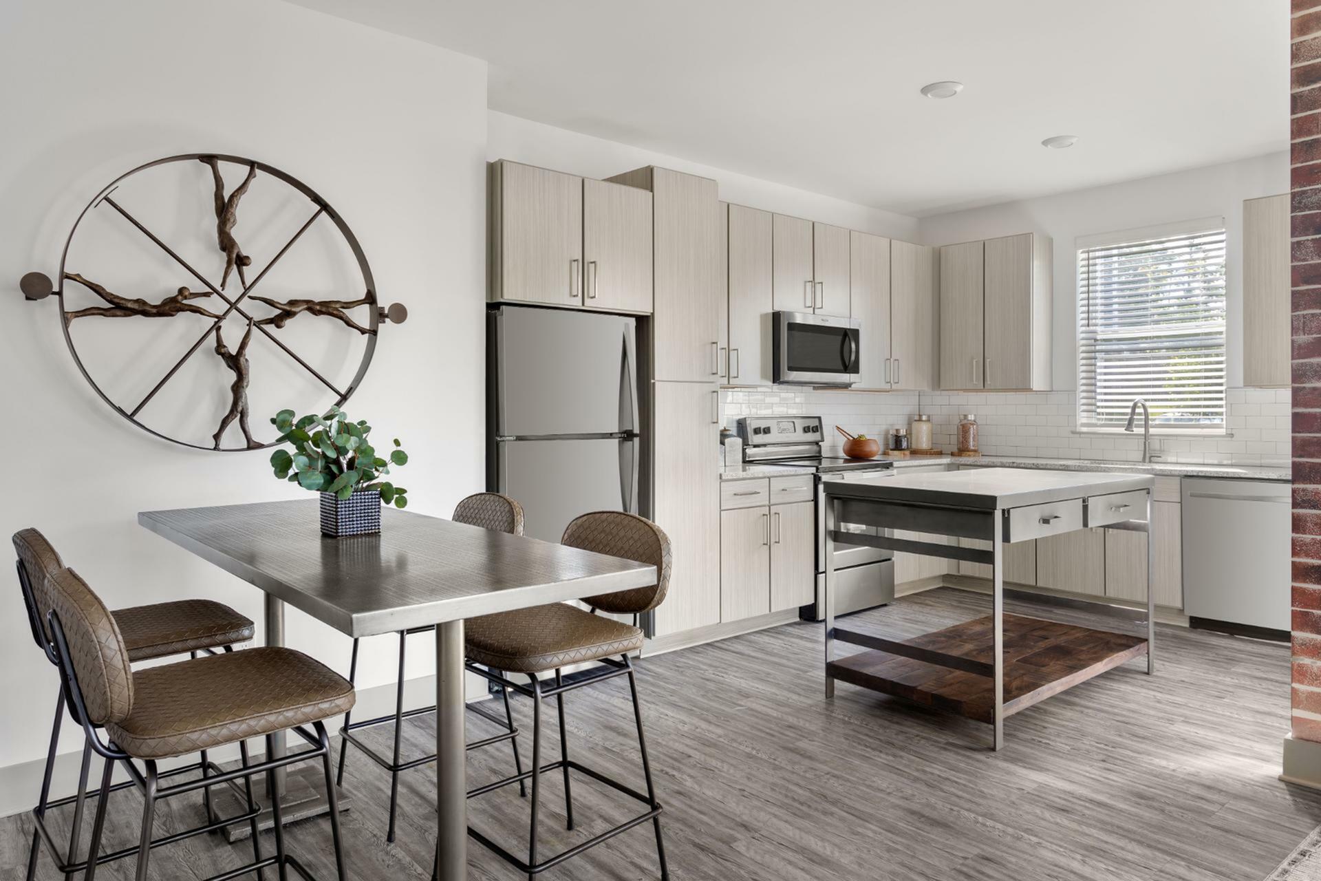 Contemporary kitchen with sleek stainless steel appliances, stylish breakfast bar, and modern decor accents.