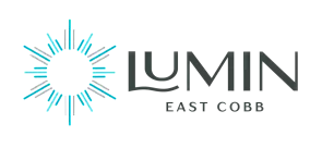 Modern and elegant logo for Lumin East Cobb, featuring a radiant sunburst design with a sleek and stylish typeface.