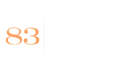 Contemporary logo with a sleek design, featuring the number 83 in vibrant orange alongside a modern, minimalist font.
