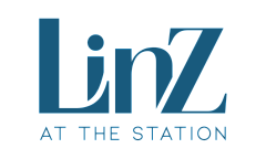 Elegant Linz at the Station logo in bold blue, encapsulating modern luxury and sophistication.