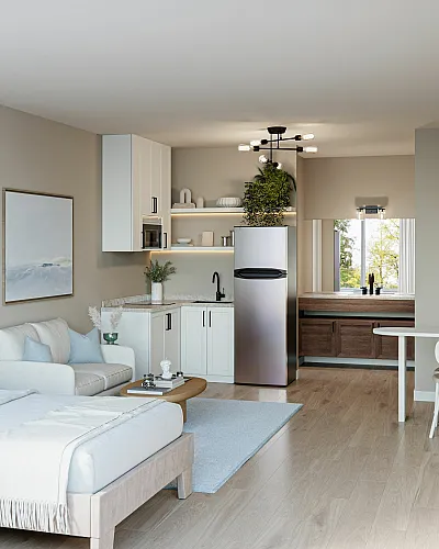 Elegant studio apartment with a cozy bed, modern kitchenette, and chic seating area featuring natural light and stylish decor.