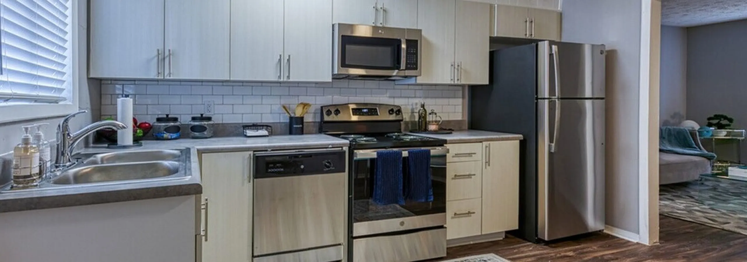 Contemporary kitchen with sleek stainless steel appliances, elegant cabinetry, and a cozy open layout, perfect for modern living.