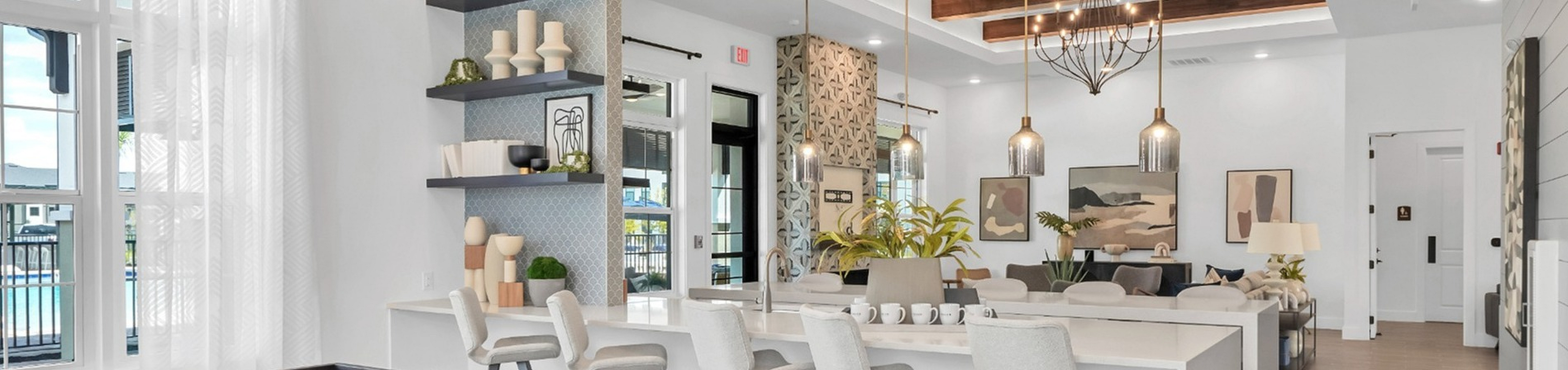 Luxurious open-concept living space featuring a modern shuffleboard table, elegant pendant lighting, and stylish seating area for entertaining.