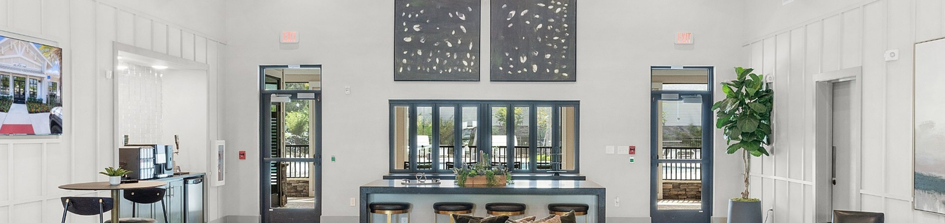 Elegant modern lounge with high ceilings, cozy seating, and chic decor perfect for relaxation and social gatherings.