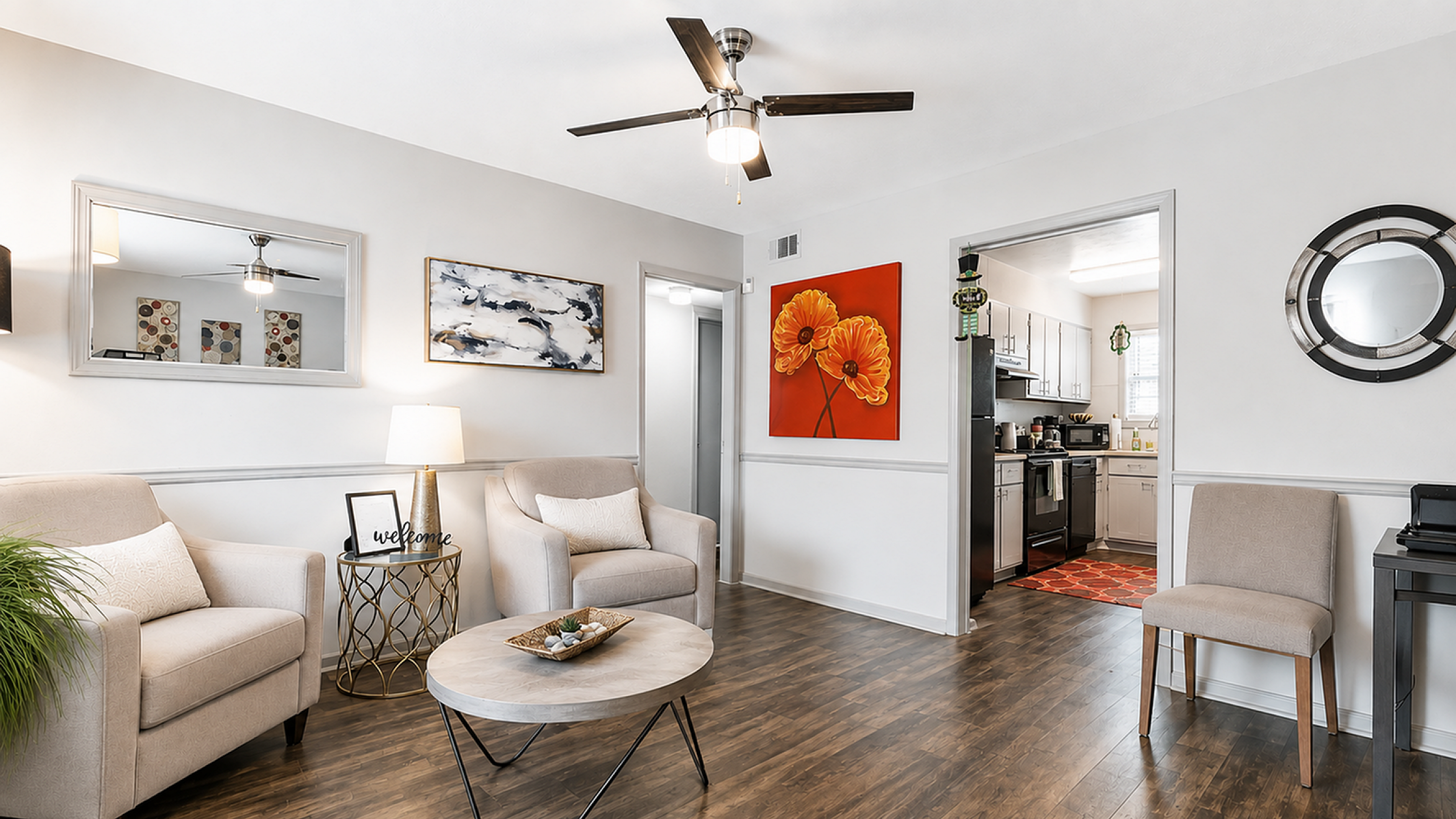 Bright and inviting living room with elegant furnishings, modern decor, and a peek into a spacious kitchen.