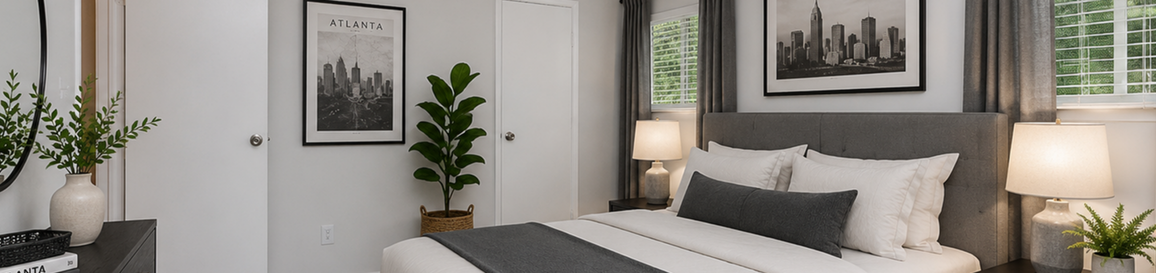 Elegant bedroom interior with modern gray decor, plush bedding, and ambient lighting, creating a cozy retreat.