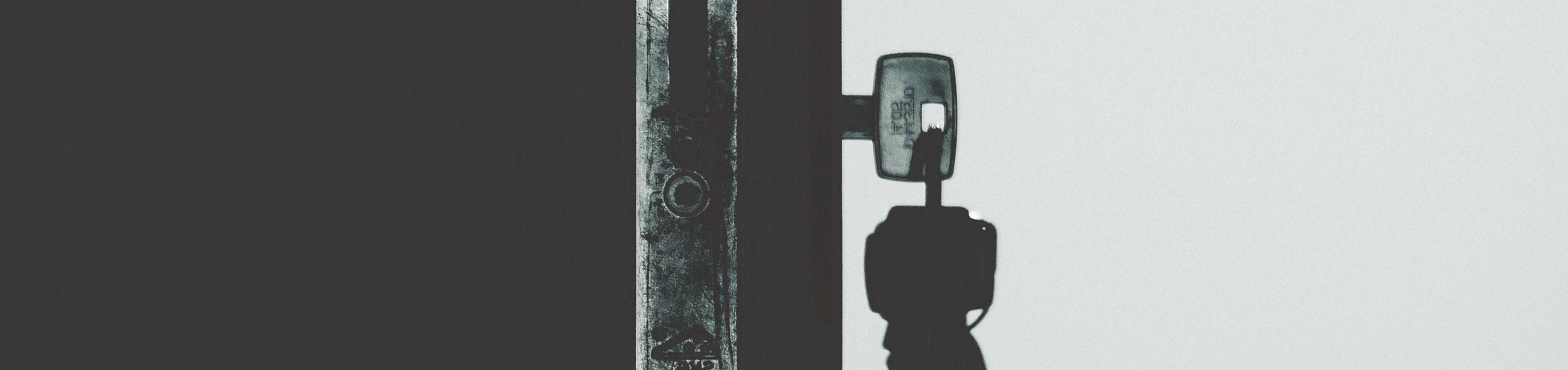 Close-up of a modern door lock with keys inserted, symbolizing security and access in a stylish apartment setting.