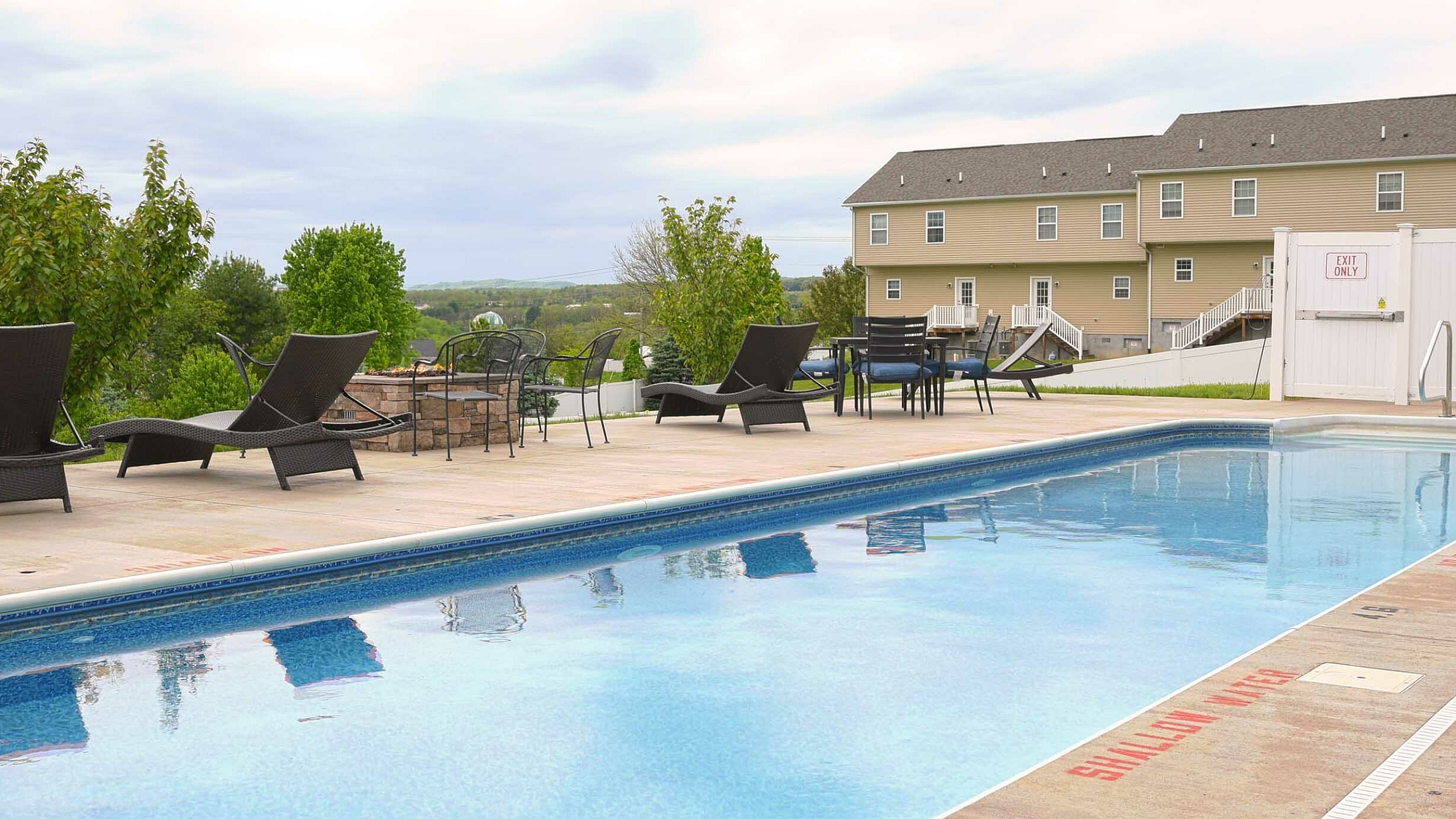 Charming outdoor pool area with comfortable loungers and scenic views, perfect for relaxation and entertaining.