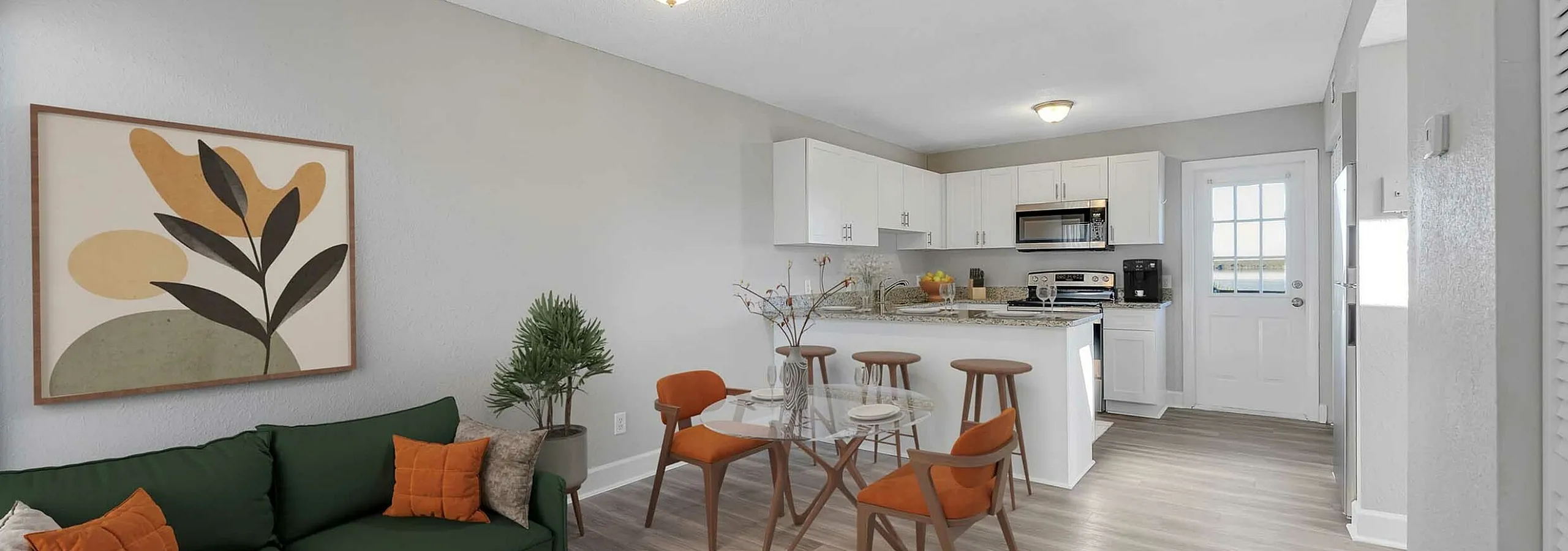 Chic open-plan living area with modern kitchen, stylish dining set, and elegant decor, creating a warm and inviting atmosphere.