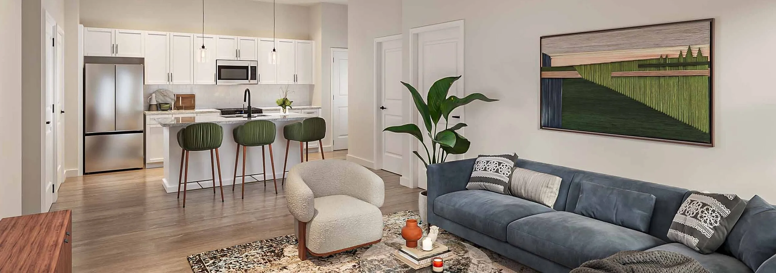 Inviting open-concept living room with plush blue sofa, stylish kitchen island, and modern stainless steel appliances.