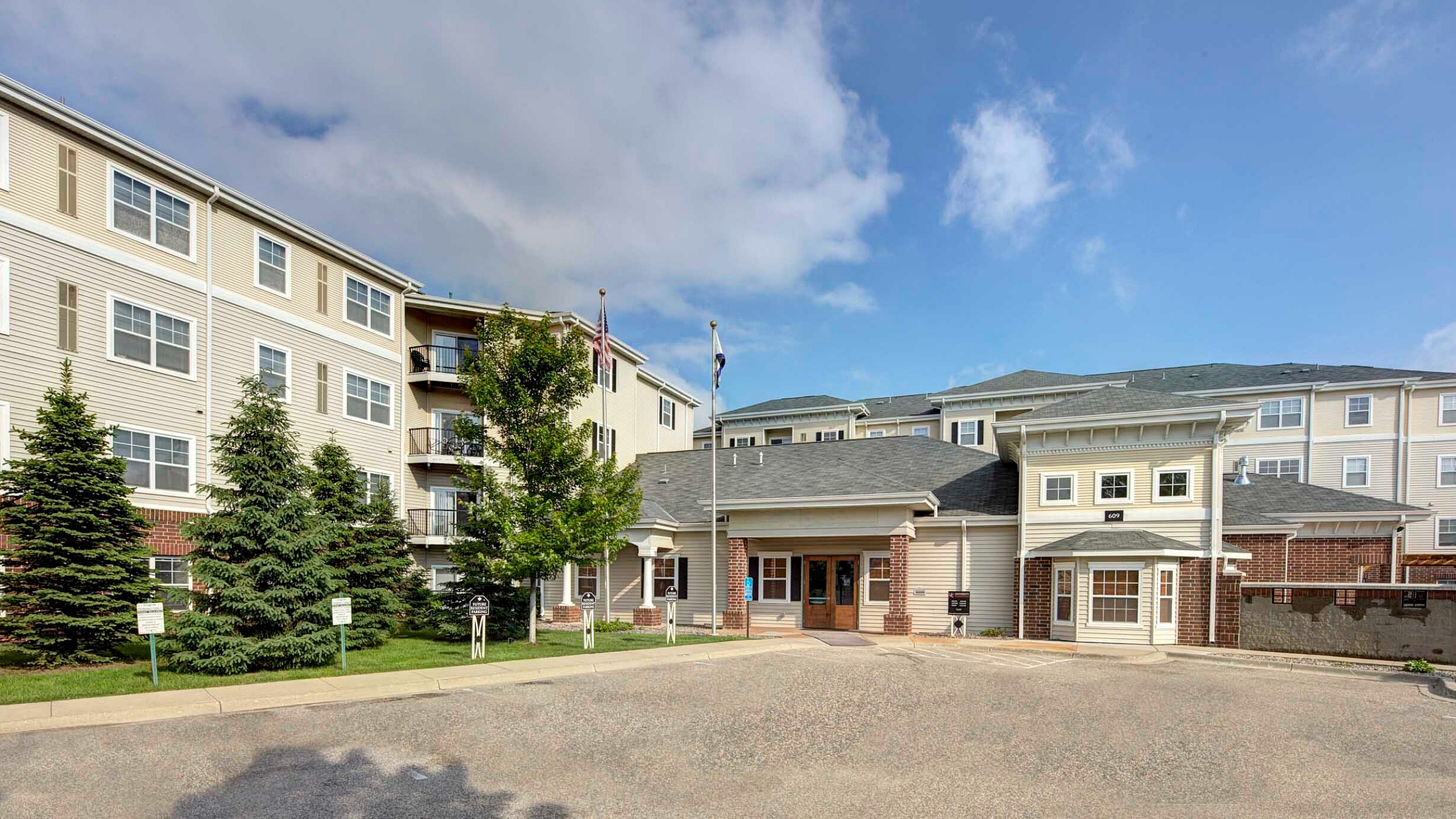 Charming apartment complex exterior with modern architecture, manicured landscaping, and inviting entryway.