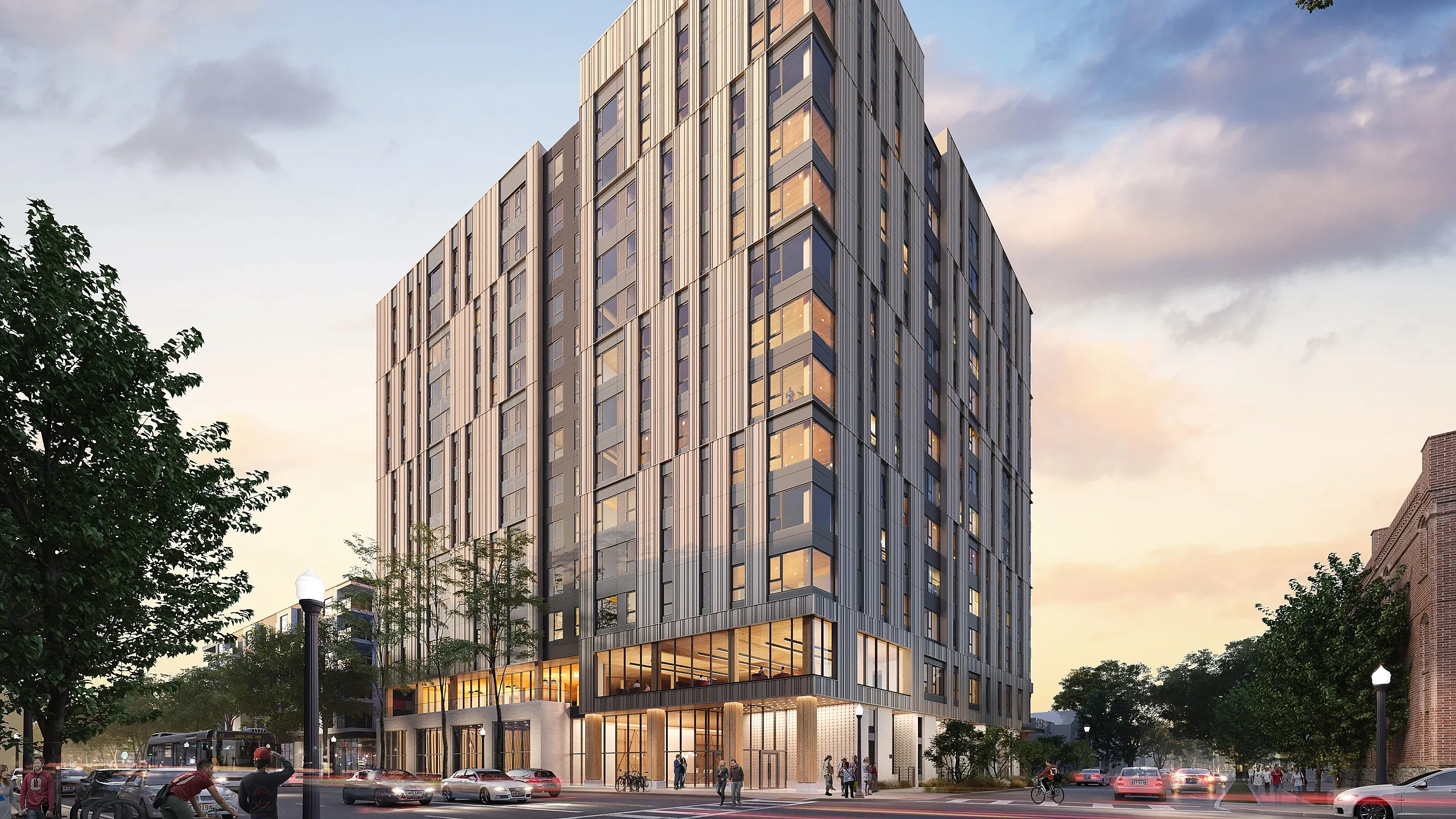 Modern high-rise apartment building with expansive windows, situated on a lively street corner at sunset, offering luxurious urban living.