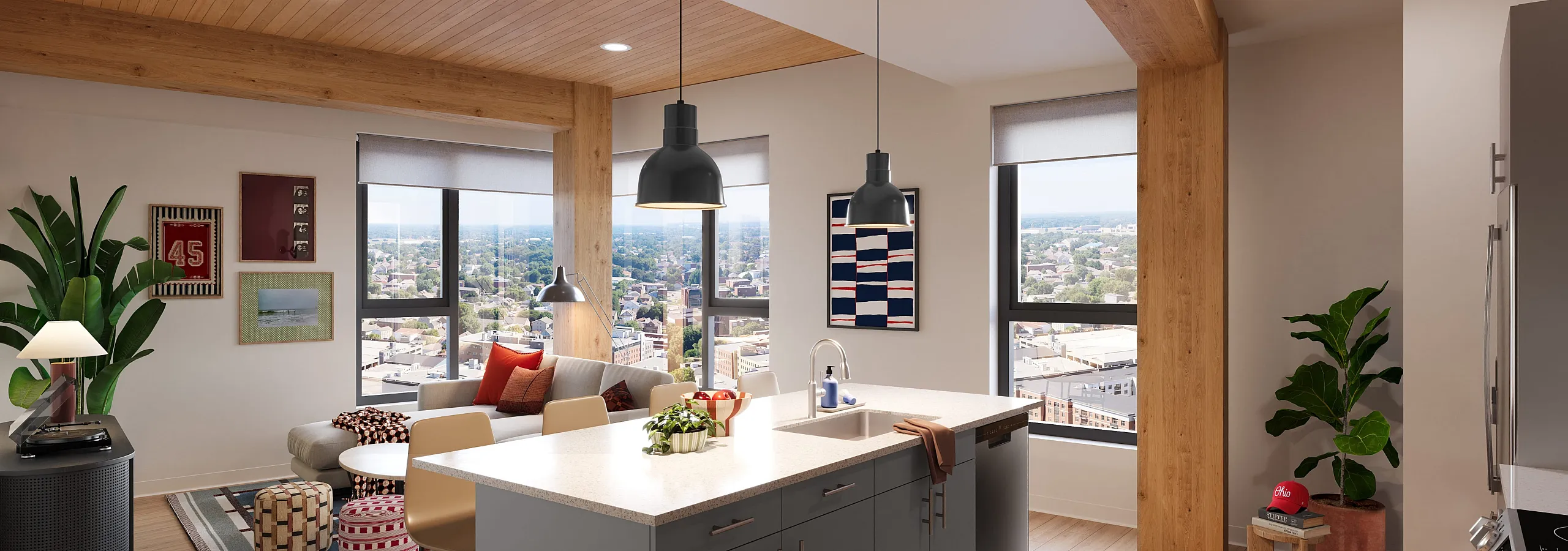 Modern open-concept living space with cozy seating area, stylish kitchen island, and panoramic city views.
