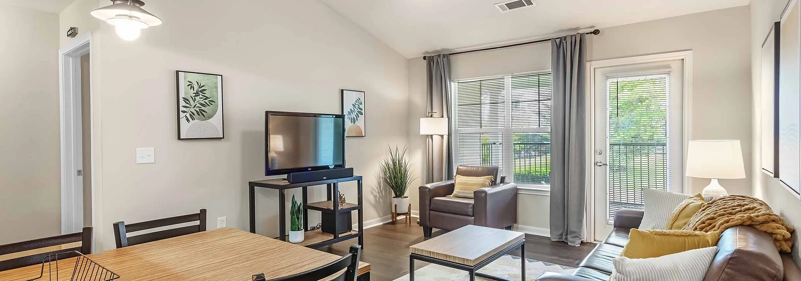 Inviting open-plan living area with modern decor, featuring a cozy seating arrangement and abundant natural light.