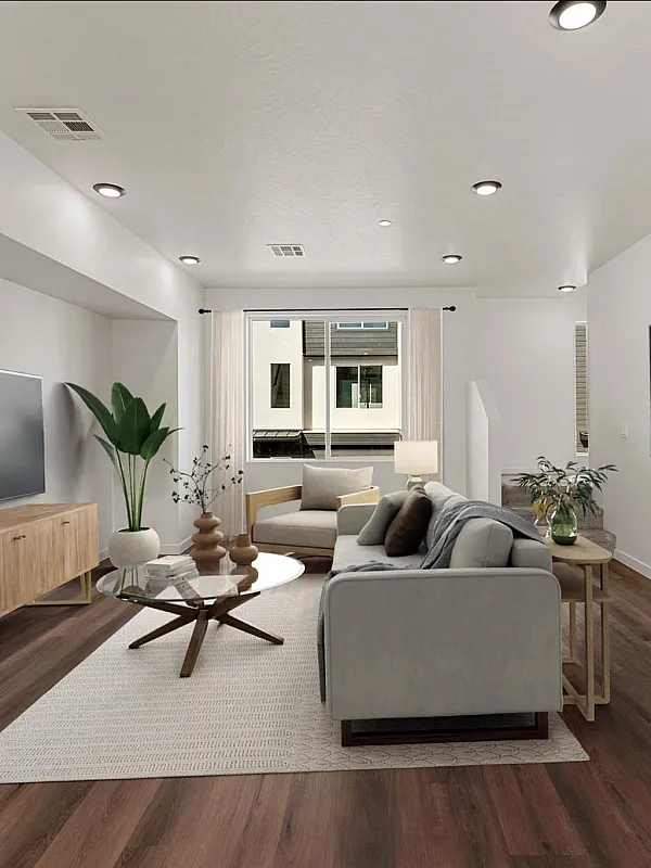 Bright modern living room with sleek hardwood floors, stylish furniture, and abundant natural light from large window.