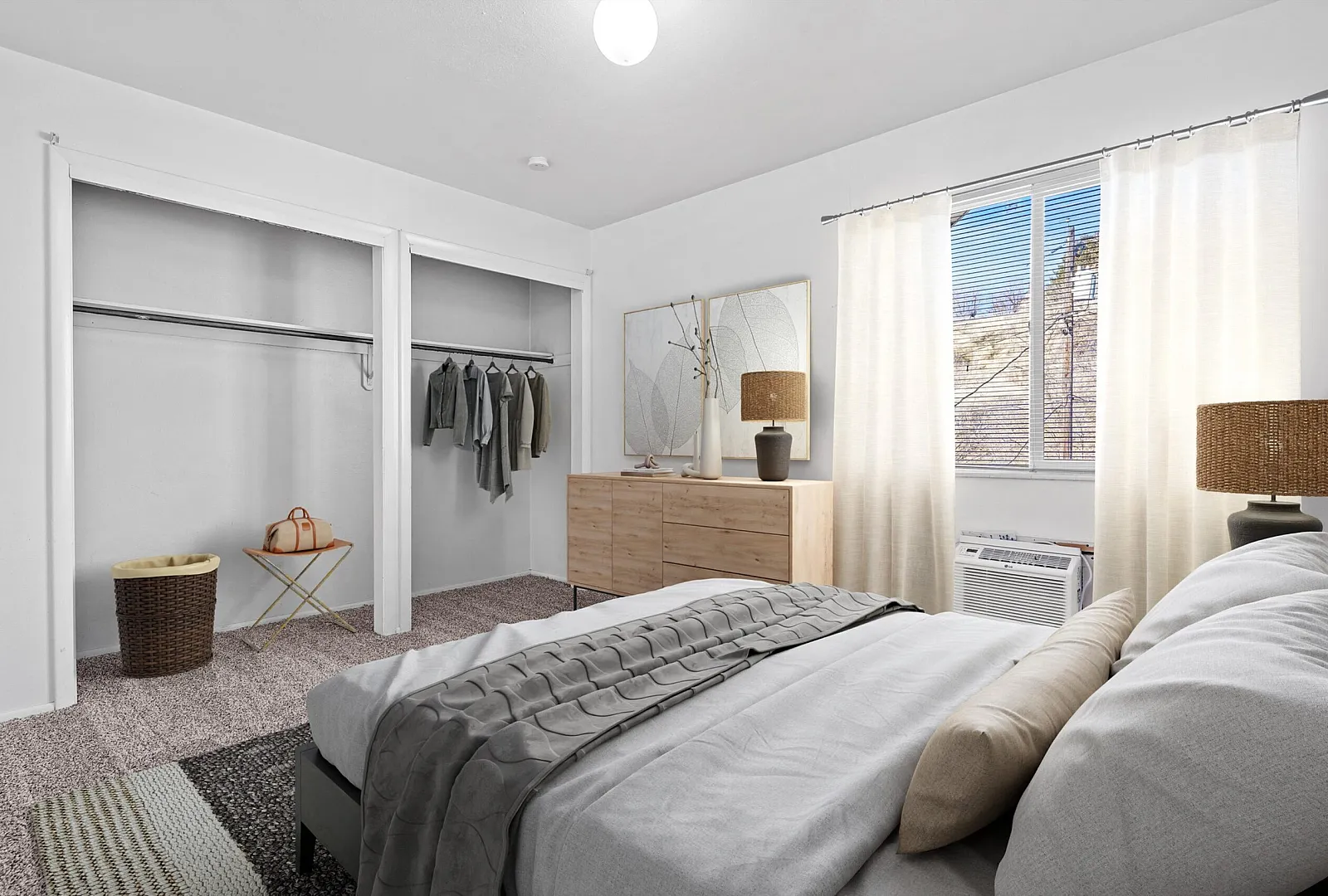 Bright and airy bedroom featuring a large closet, stylish dresser, and cozy bed, accented by natural light from a spacious window.