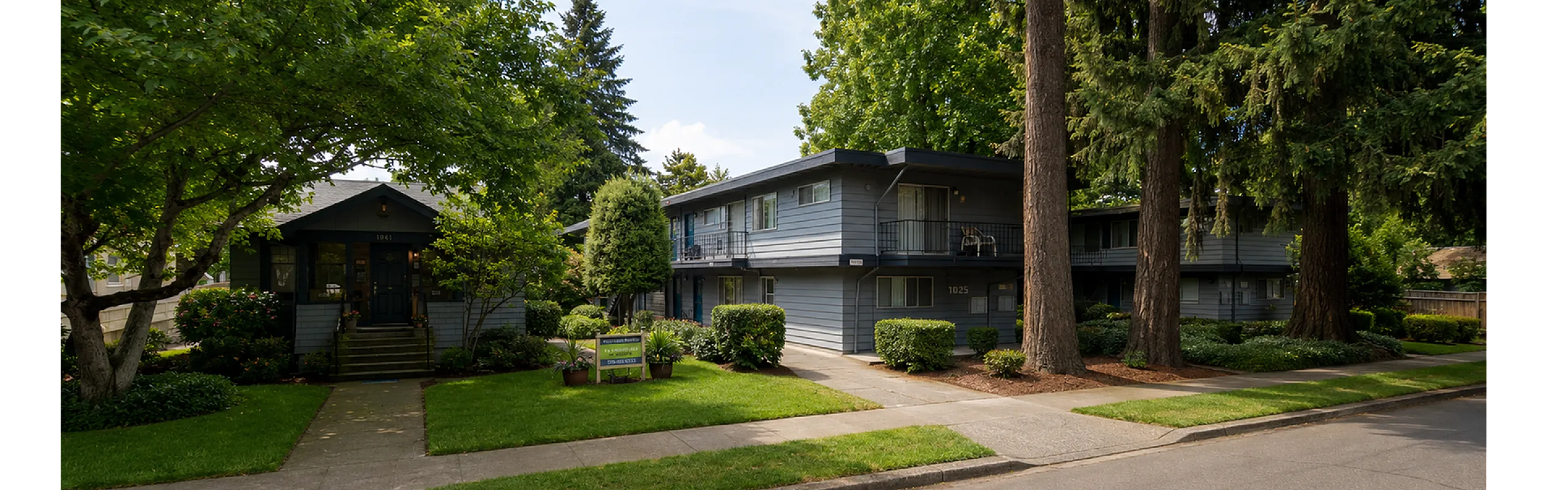 Charming apartment complex surrounded by lush greenery, featuring inviting pathways and cozy residential buildings.