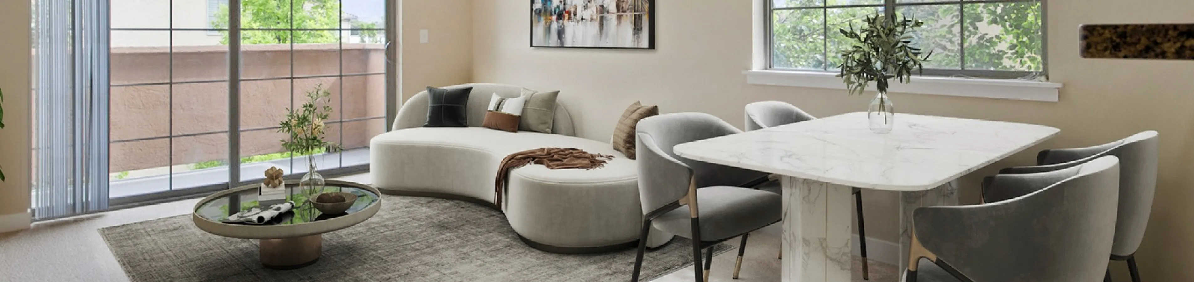 Bright and airy living-dining area with large windows, featuring modern furniture and elegant decor, perfect for relaxation and entertaining.